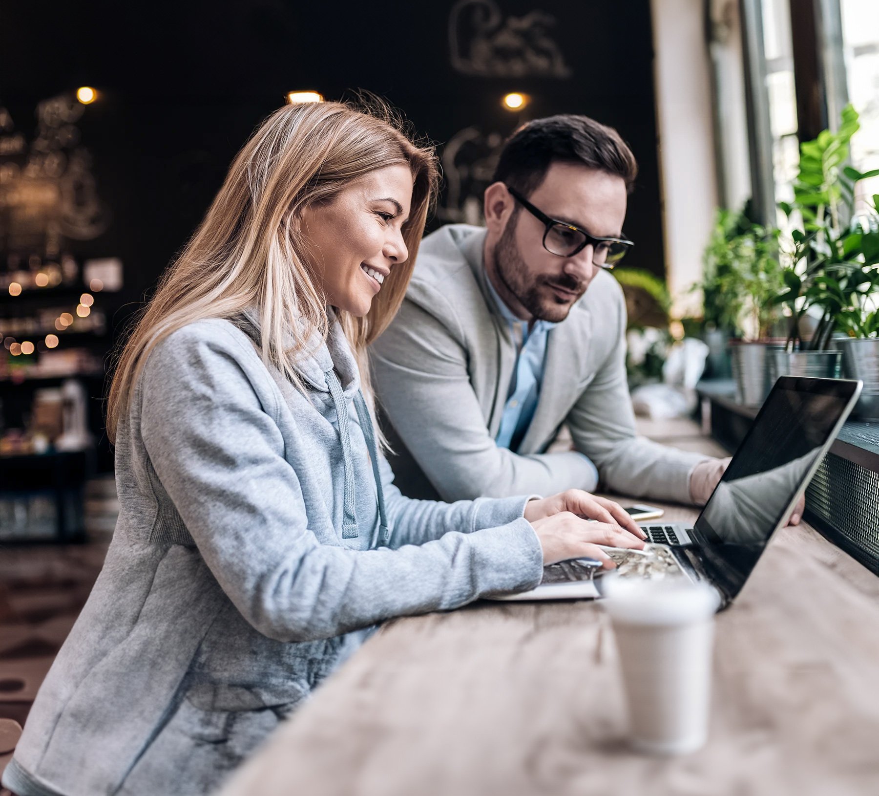 Female-and-male-looking-at-laptop-AI2